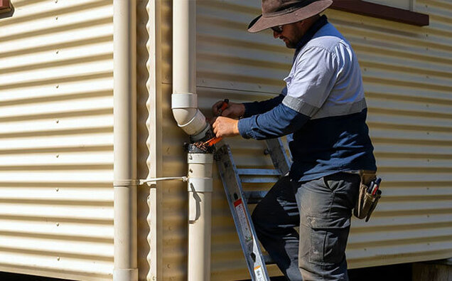 Plumber Clearing Downpipe